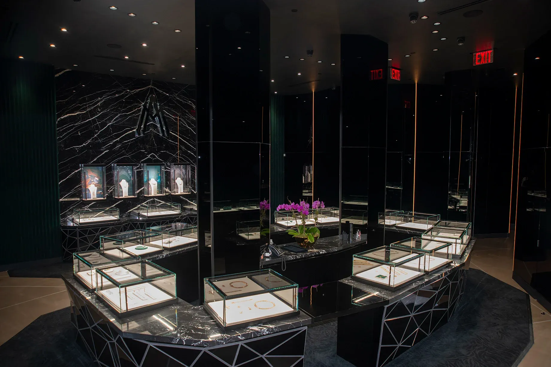 Alex Moss NY luxury jewelry showroom with black marble display cases and glass vitrines