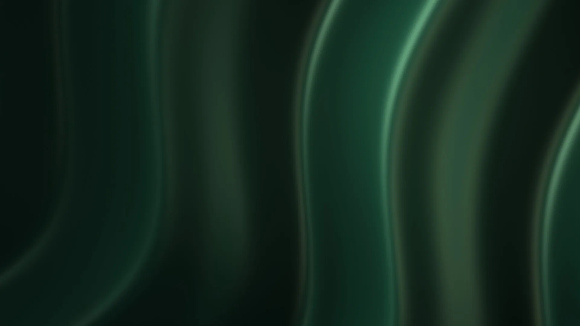 Soft green light moving across a dark surface