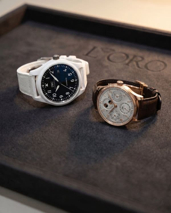 IWC Pilot in white ceramic beside an IWC Portugieser perpetual calendar in rose gold