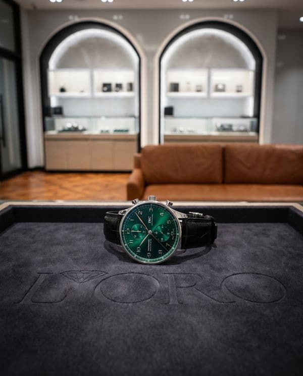 IWC Portugieser Chronograph with green dial on an embossed felt tray inside a boutique