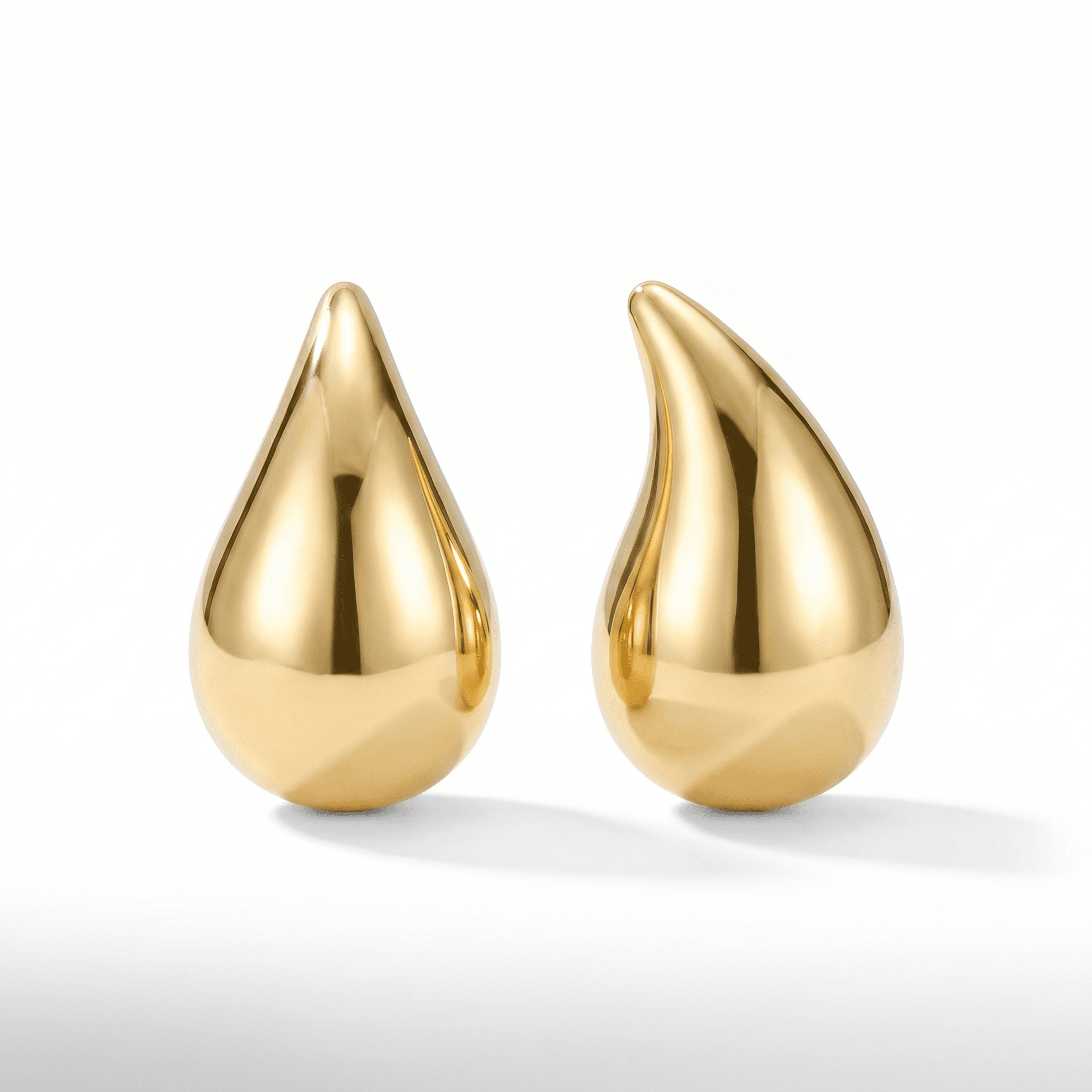 Gold teardrop earrings on a white e-commerce background
