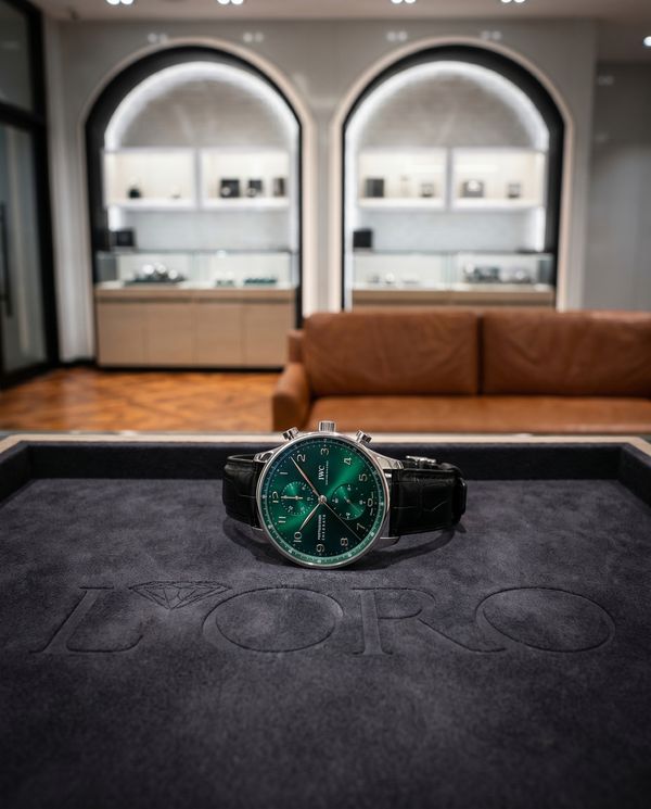 IWC Portugieser Chronograph with green dial on an embossed felt tray inside a boutique