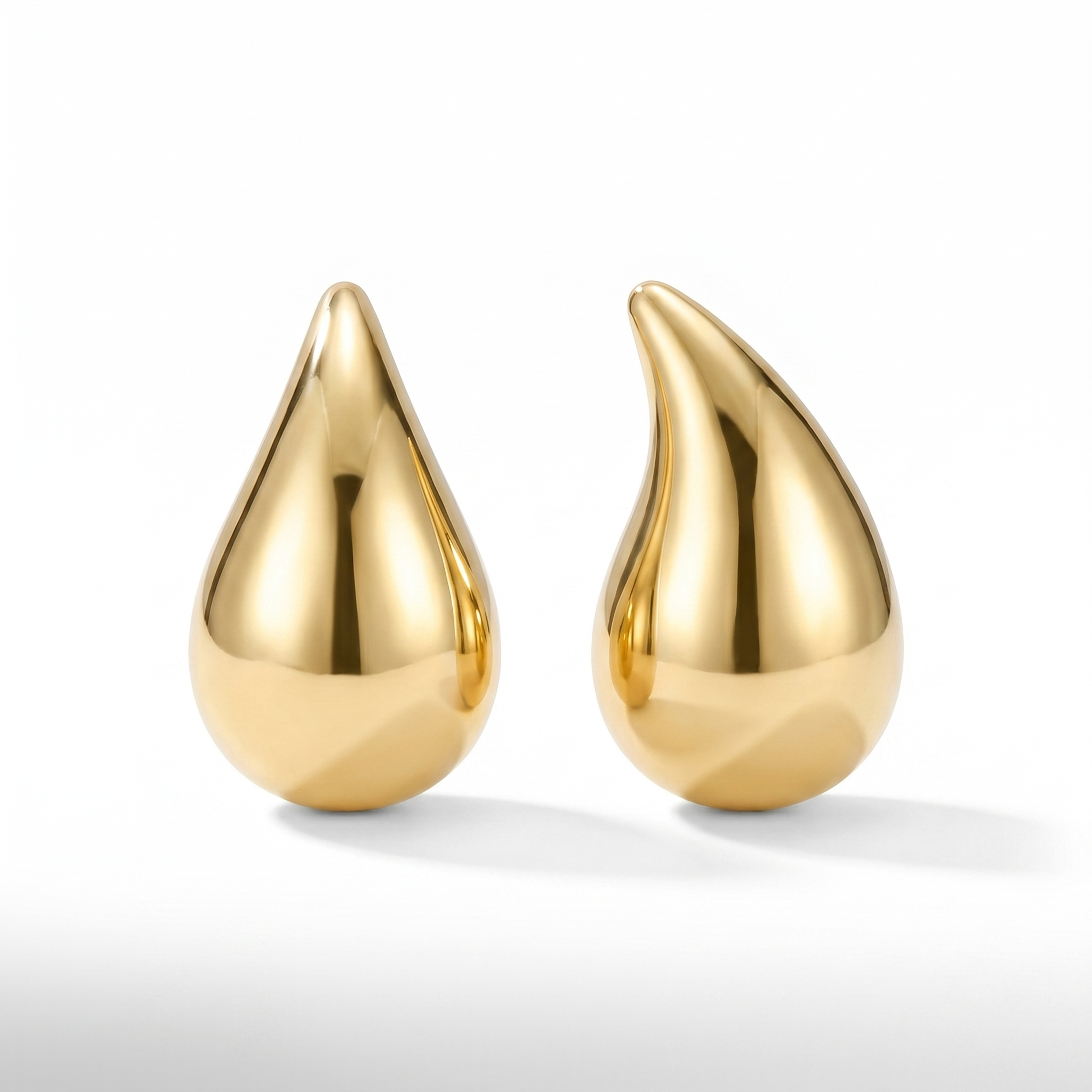 Gold teardrop earrings on a white e-commerce background